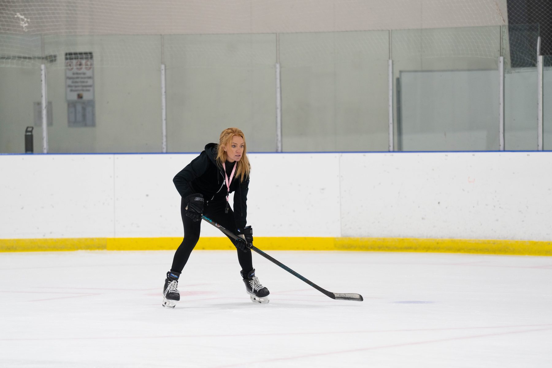 Stacy Allen in a ready stance at centre ice, stick on the ice
